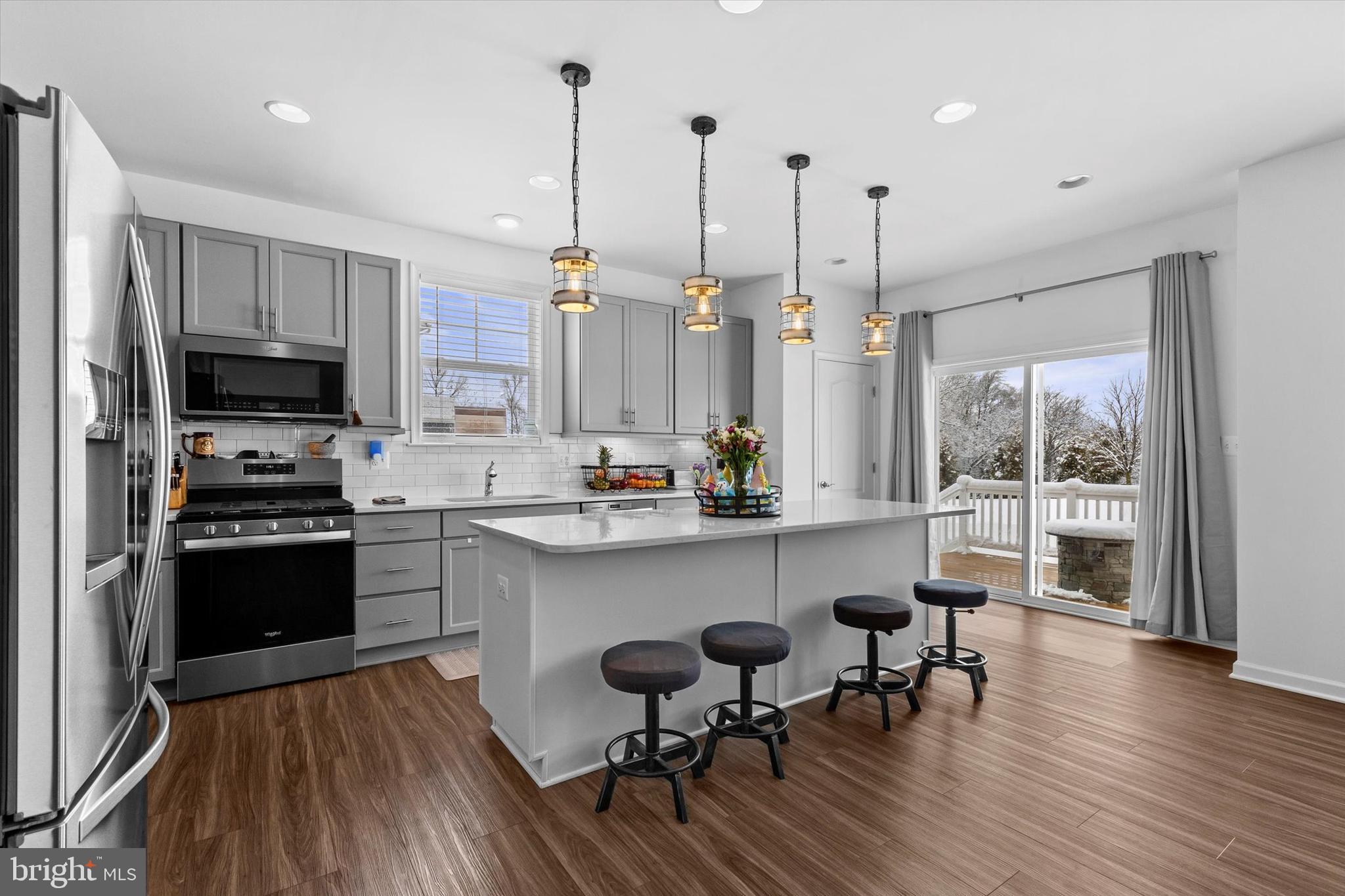 138 Pheasant Ridge Road Hanover, PA 17331 - Photo 5 of 45 a kitchen with stainless steel appliances a dining table chairs stove and a wooden floor