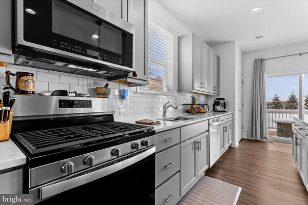 a kitchen with wooden cabinets and a stove top oven