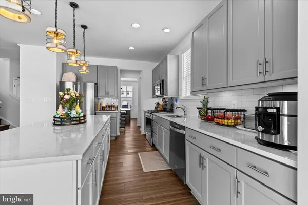 a kitchen with lots of counter top space and wooden floor