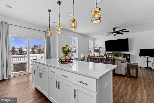 a kitchen with stainless steel appliances granite countertop a stove and a wooden floors