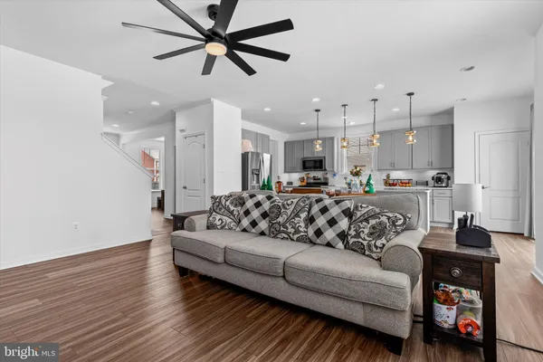 a living room with furniture and kitchen view
