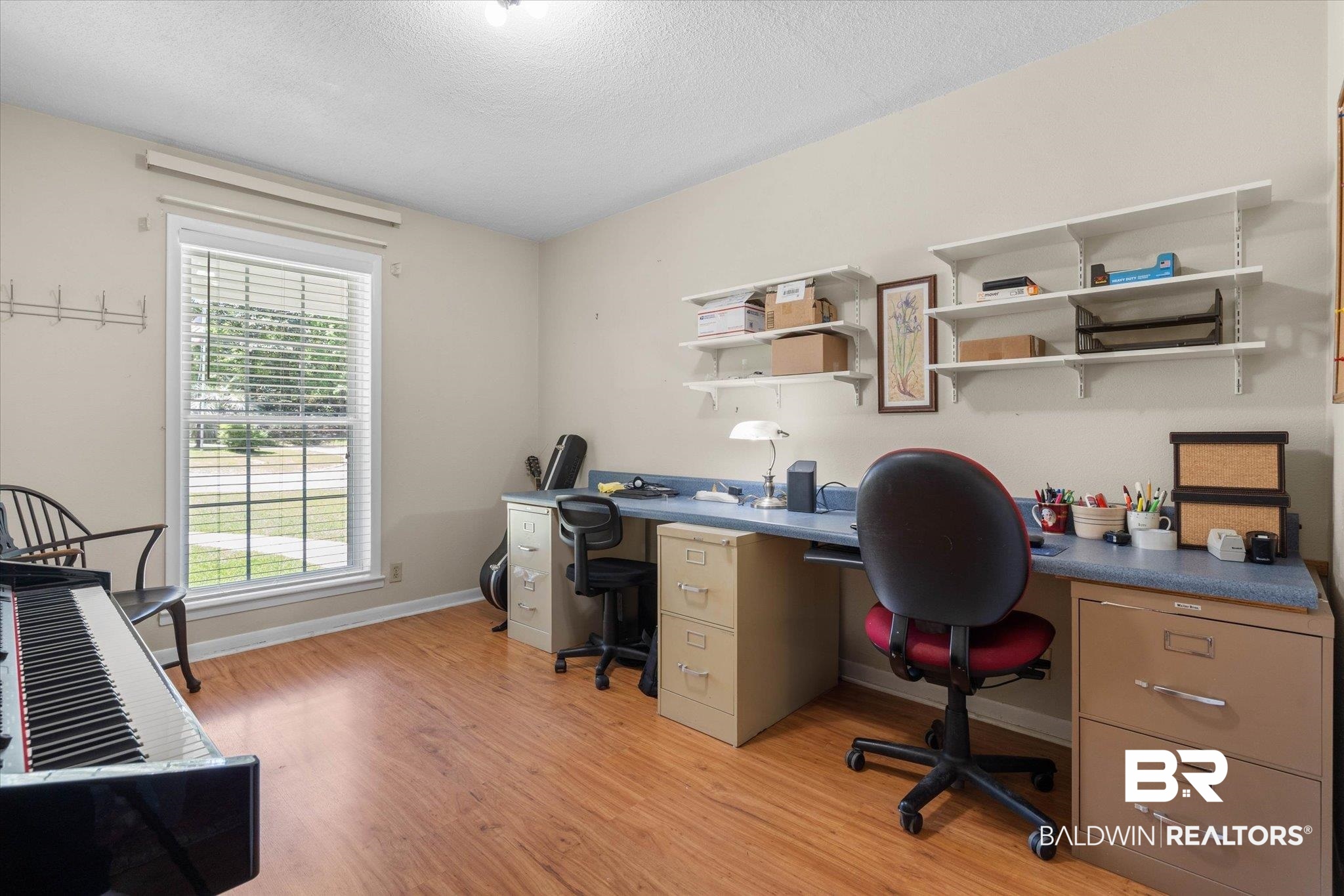 706 Sutherland Drive Chickasaw, AL 36611 - Photo 19 of 33 Office area featuring light wood finished floors, baseboards, and a textured ceiling