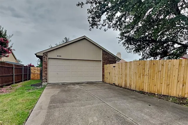 a view of a garage with a small yard