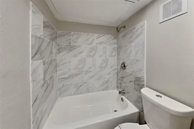 a bathroom with a bathtub and a toilet