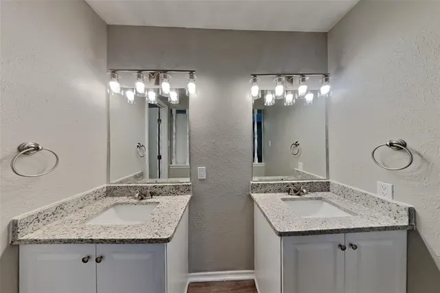 a bathroom with a granite countertop sink a large mirror and a sink