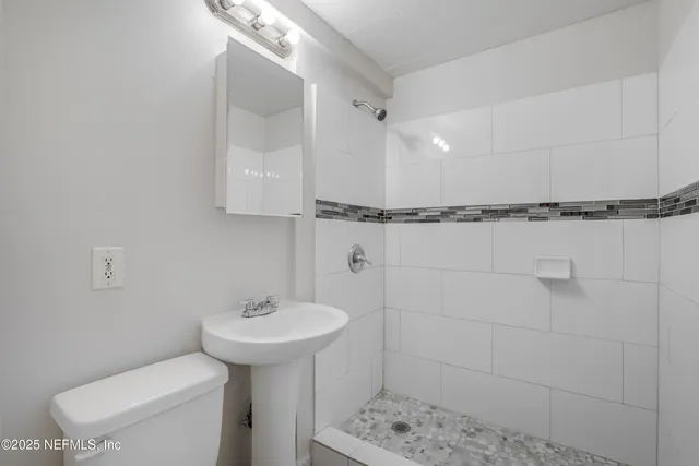 a bathroom with a sink toilet and shower