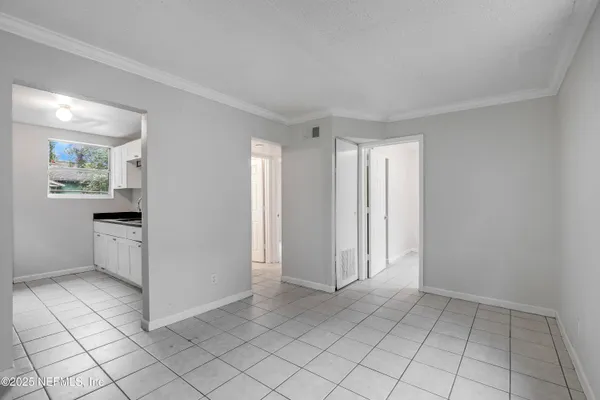 a view of a kitchen with white cabinets