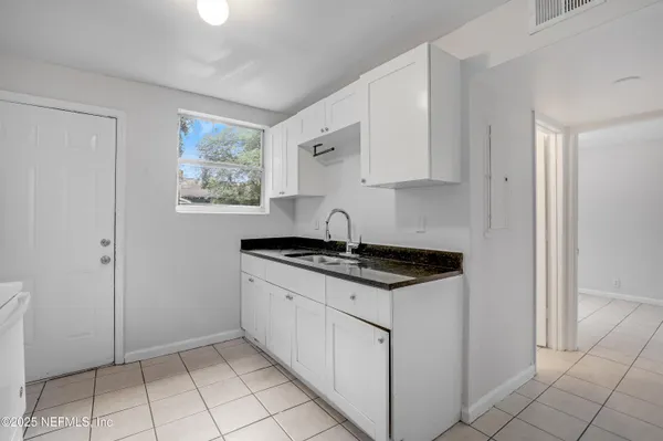 a kitchen with stainless steel appliances a sink stove and cabinets