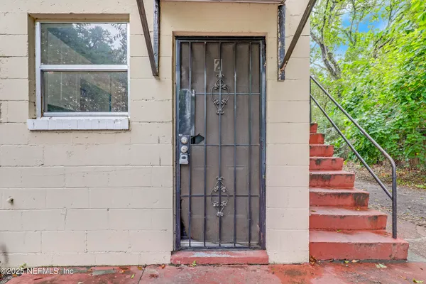 a view of staircase with white walls and windows