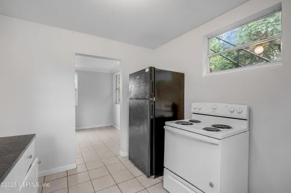 a kitchen with a refrigerator sink stove and cabinets