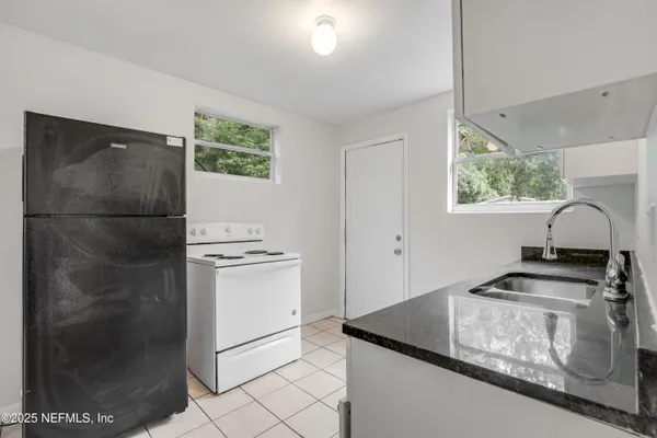 a kitchen with stainless steel appliances granite countertop a refrigerator and a stove