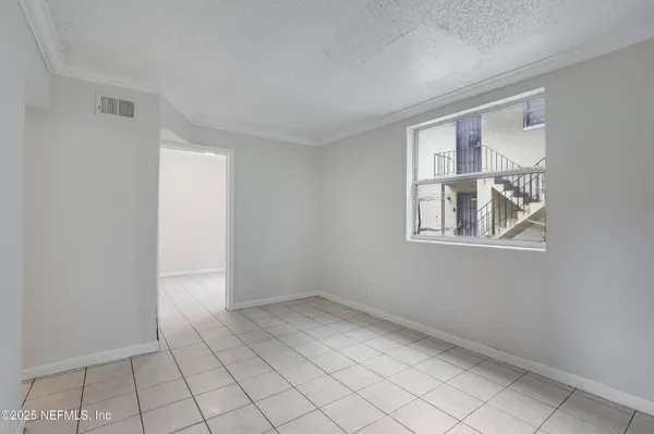 a view of an empty room with windows