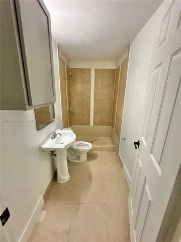 a bathroom with a sink a toilet and mirror