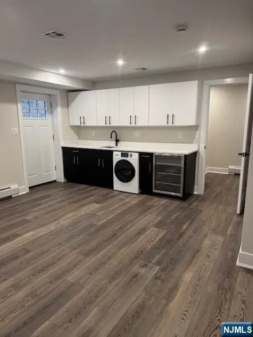 a view of kitchen with cabinets and wooden floor