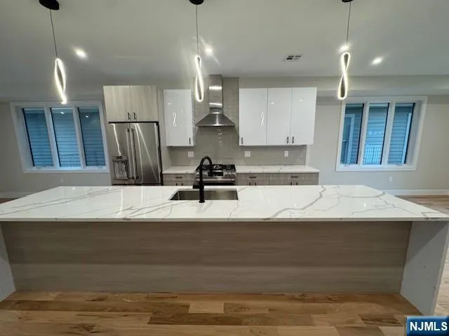 a kitchen with a refrigerator and microwave