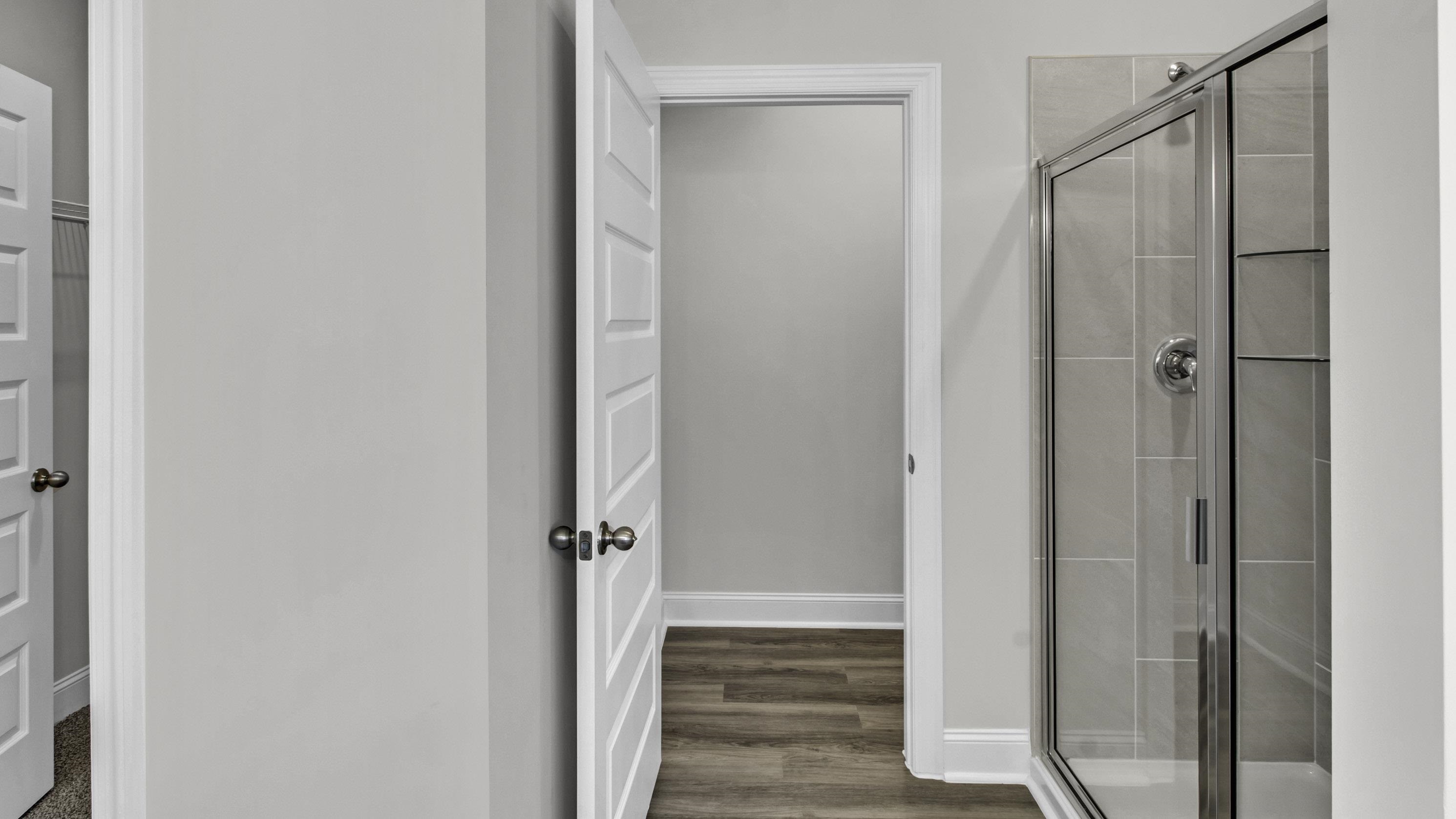 990 Mewborn Farm Road Oakland, TN 38060 - Photo 19 of 40 Bathroom with a shower stall and dark wood-style flooring