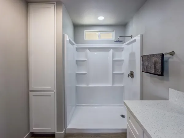 a view of a hallway with closet and wooden floor