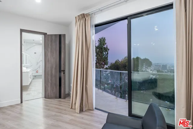 a bedroom with a bed and a flat screen television