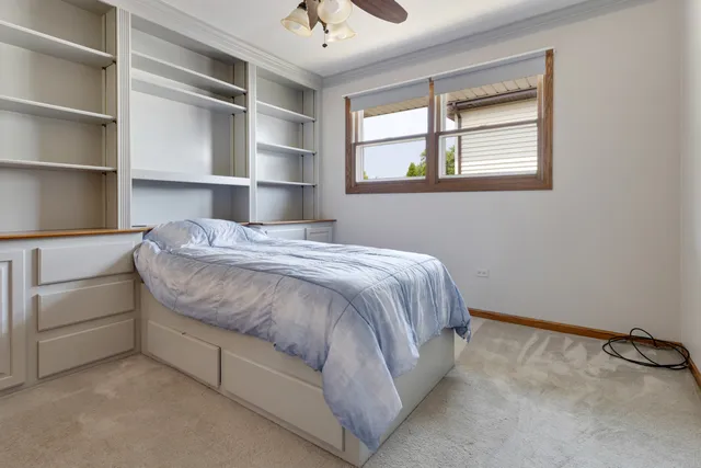 a bed sitting in a bedroom next to a window