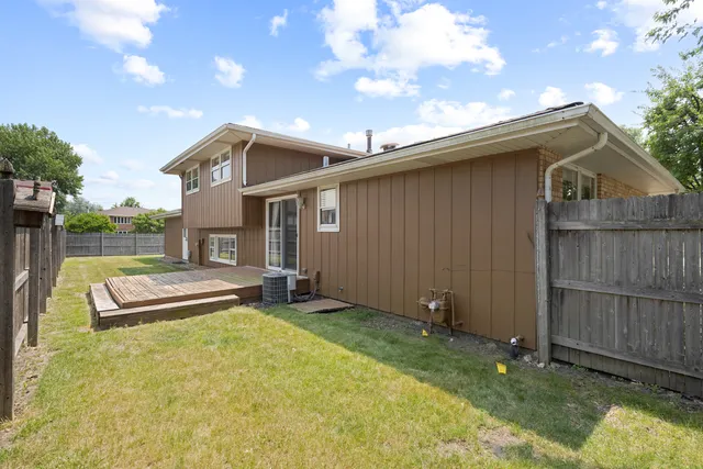a view of a house with a backyard and a patio