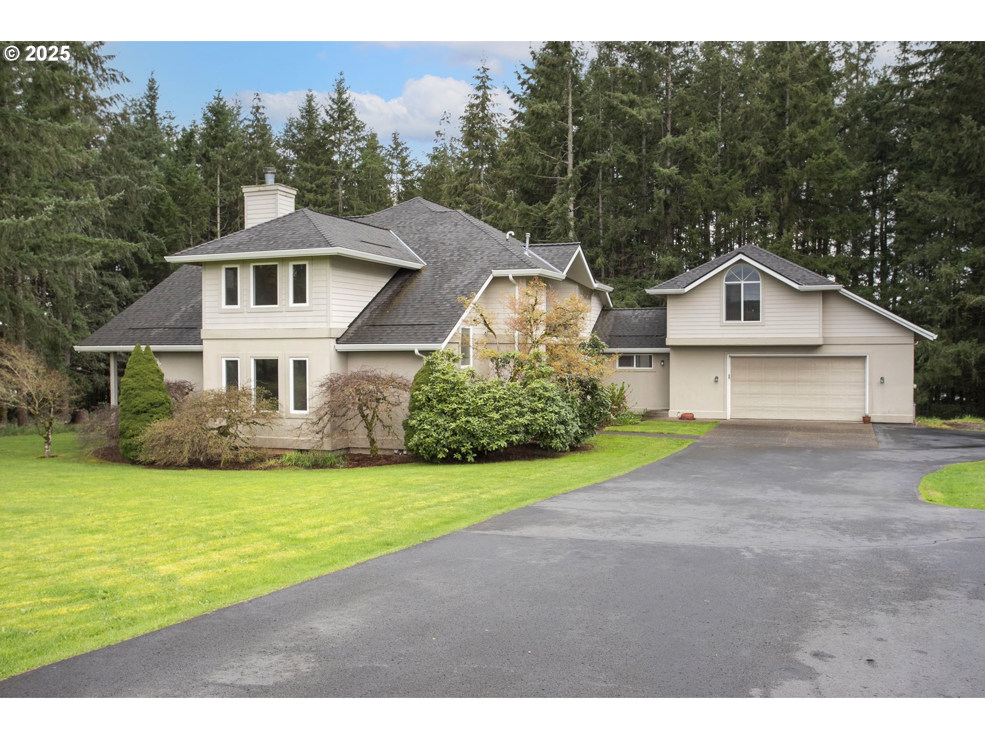 32370 Southeast Judd Road Eagle Creek, OR 97022 - Photo 2 of 48 a front view of a house with a yard and garage