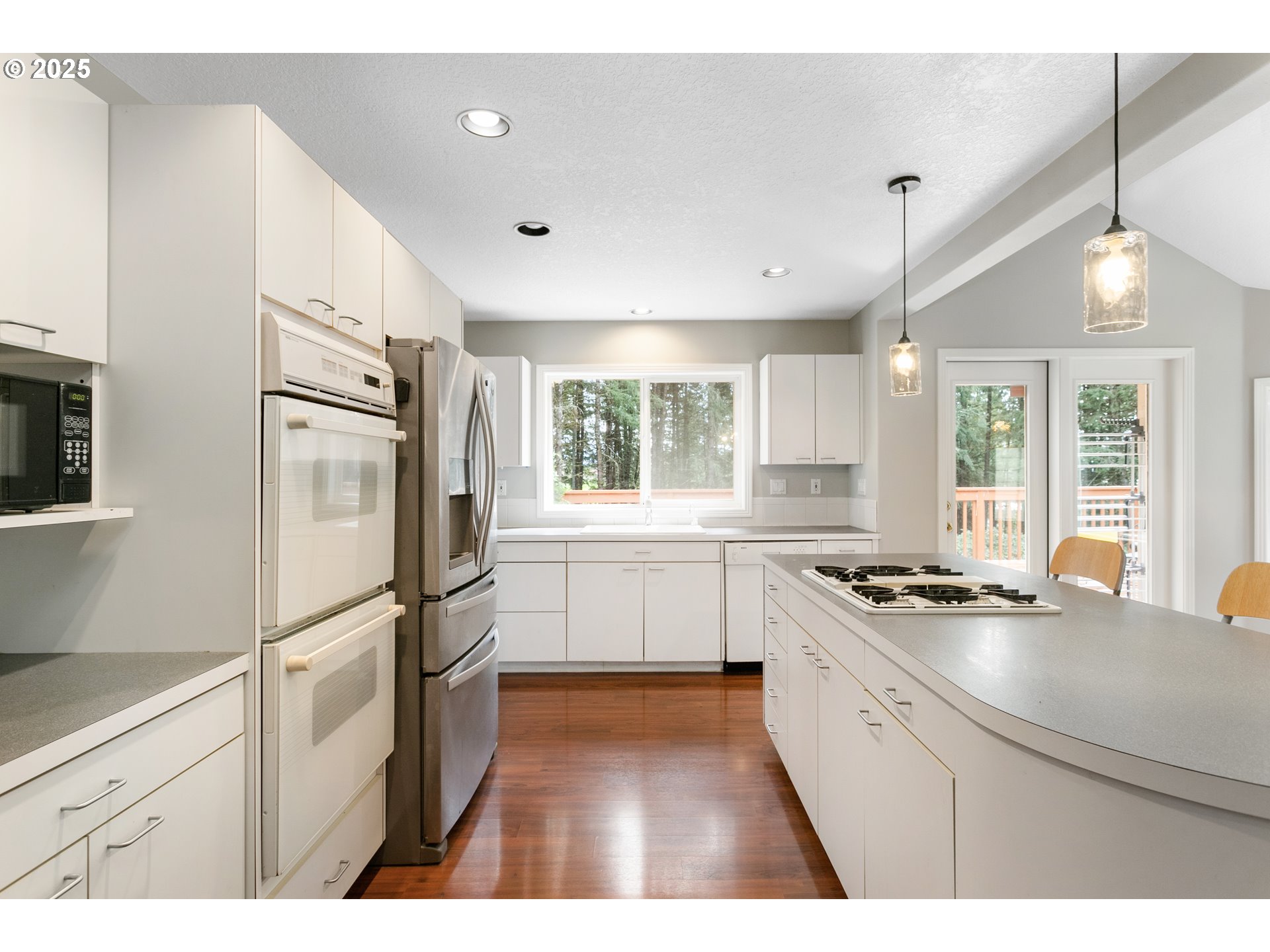 32370 Southeast Judd Road Eagle Creek, OR 97022 - Photo 21 of 48 a kitchen with a refrigerator a sink and white cabinets