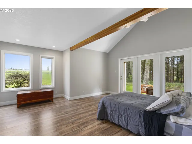 a bedroom with a bed and large window