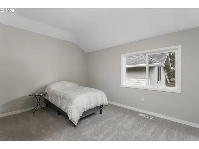 a bedroom with a bed window and wall painting
