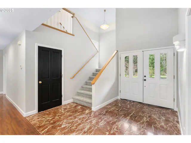 a view of an entryway with wooden floor