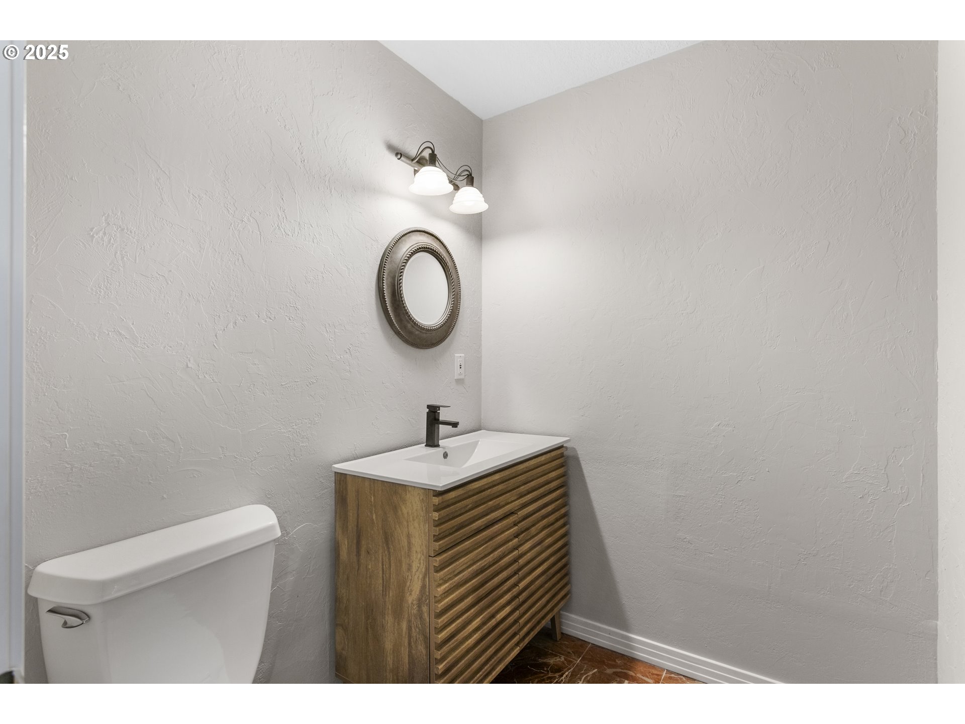 32370 Southeast Judd Road Eagle Creek, OR 97022 - Photo 6 of 48 a bathroom with a sink a toilet and a mirror