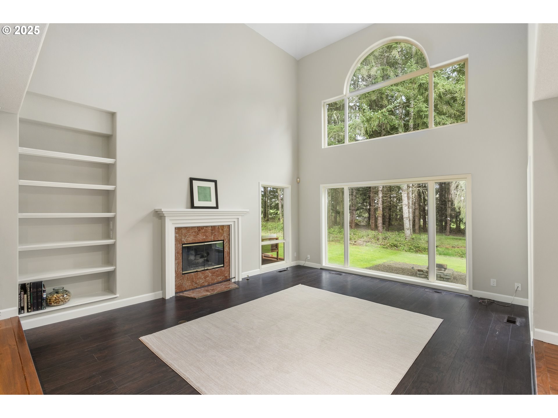 32370 Southeast Judd Road Eagle Creek, OR 97022 - Photo 9 of 48 a view of an empty room with a fireplace and wooden floor