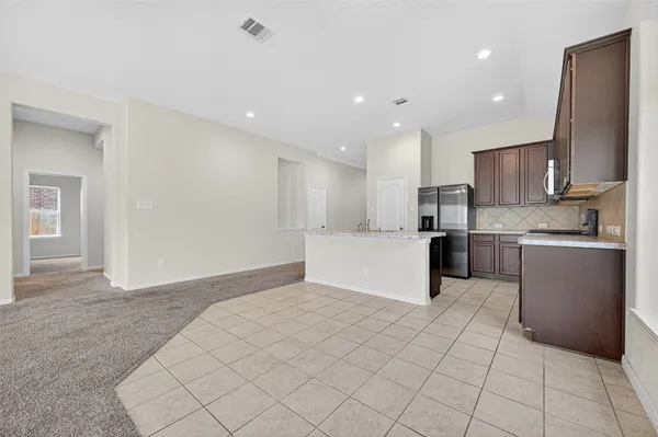 a kitchen with stainless steel appliances granite countertop a refrigerator sink and cabinets