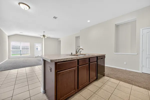 a spacious bathroom with a granite countertop sink a mirror and a vanity