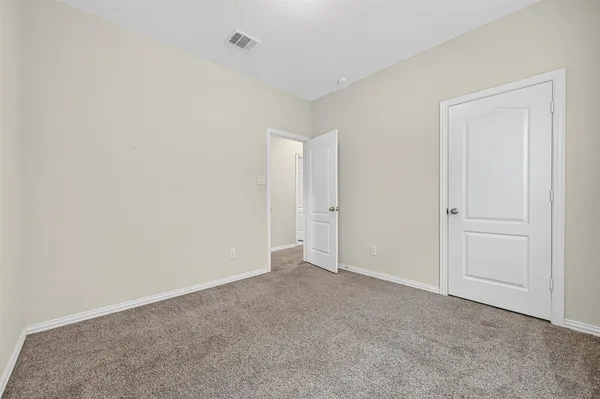 a view of an empty room and closet area