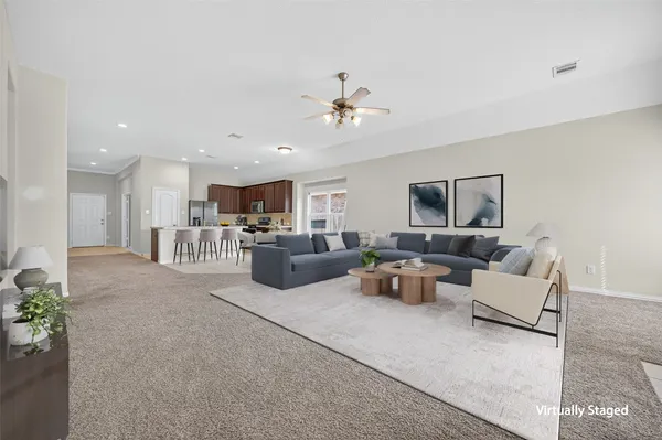 a living room with furniture and a chandelier