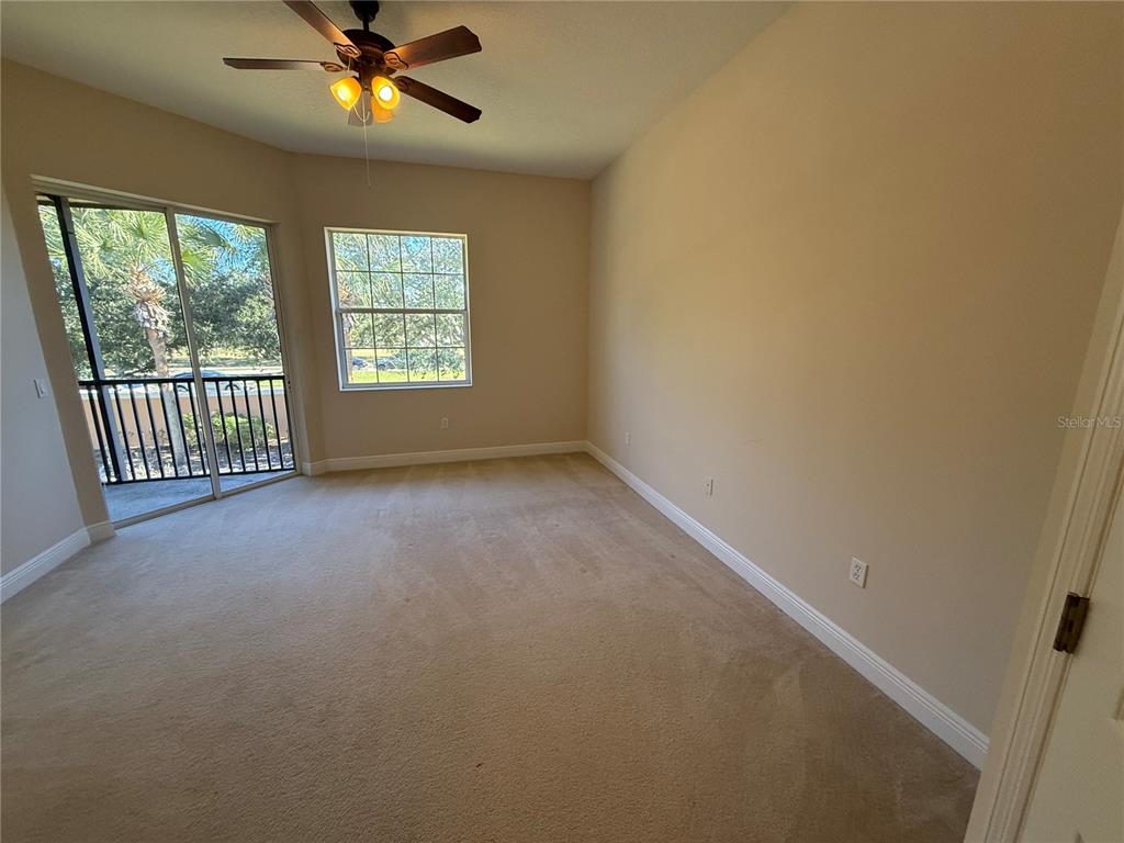 8153 Miramar Way Lakewood Ranch, FL 34202 - Photo 17 of 42 an empty room with windows and fan