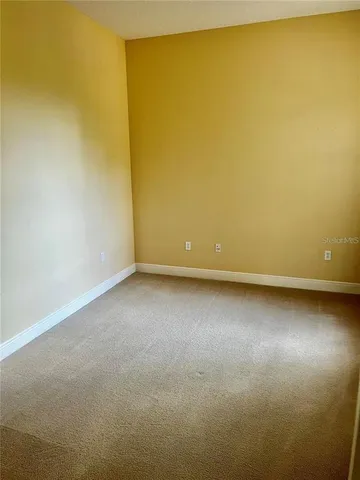 a view of a room with wooden floor and windows