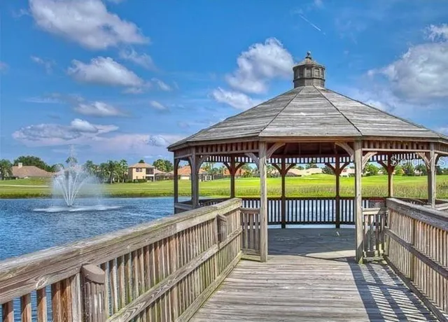a view of a patio with a table and chairs under an umbrella