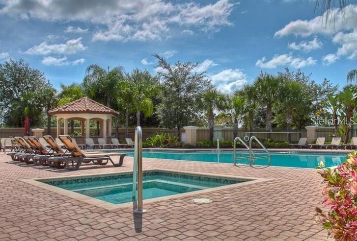 8153 Miramar Way Lakewood Ranch, FL 34202 - Photo 32 of 42 a front view of a house with garden