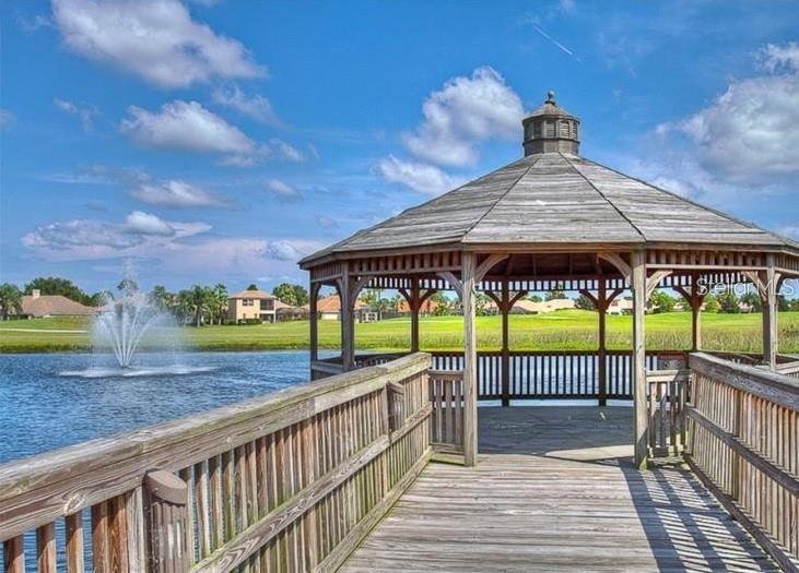 8153 Miramar Way Lakewood Ranch, FL 34202 - Photo 36 of 42 a view of a patio with a table and chairs under an umbrella