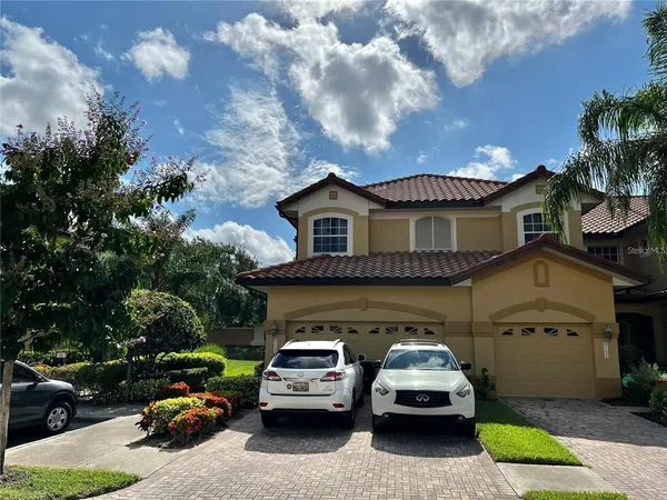 a kitchen with kitchen island granite countertop a sink and a stove top oven with wooden floor
