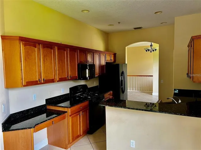 a kitchen with stainless steel appliances a refrigerator and a stove top oven
