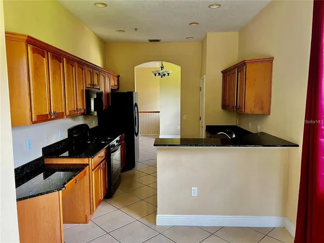 a kitchen with stainless steel appliances a stove a refrigerator a sink and dishwasher