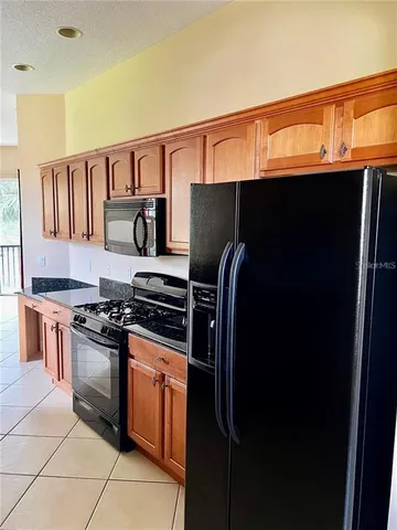 a kitchen with a stove and a refrigerator