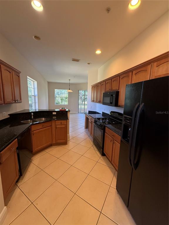 8153 Miramar Way Lakewood Ranch, FL 34202 - Photo 10 of 42 a kitchen with stainless steel appliances a refrigerator and a sink