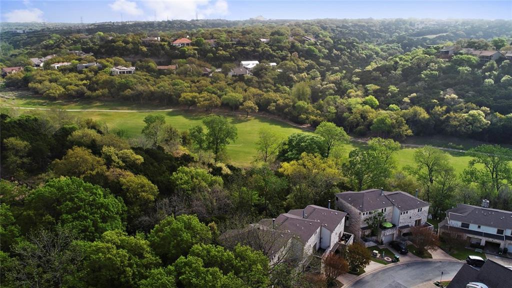 9201 Simmons Road, Unit 117 Austin, TX 78759 - Photo 4 of 11 Neighborhood setting featuring mature trees and a manicured green space