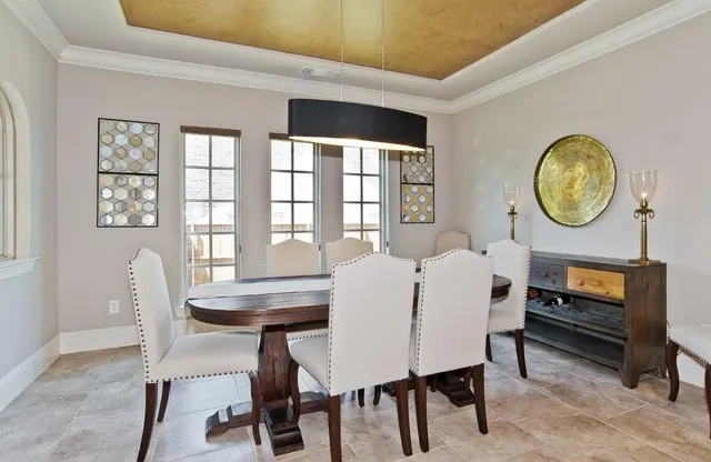 a view of a dining room with furniture and window