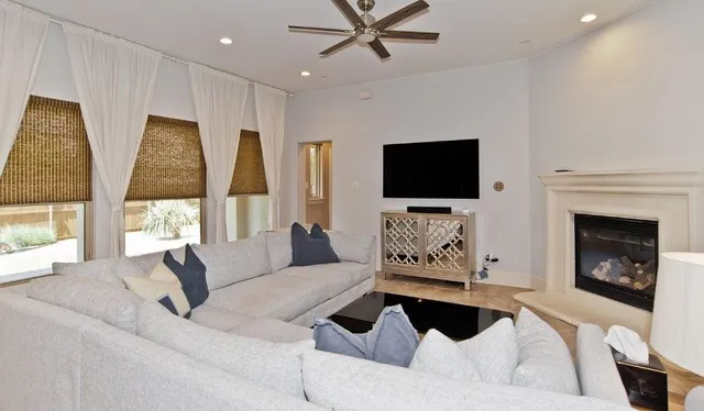 a living room with furniture fireplace and flat screen tv