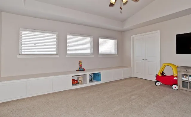 a bedroom with furniture and a lamp