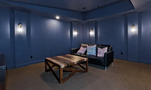 a bedroom with a large bed and a chandelier fan